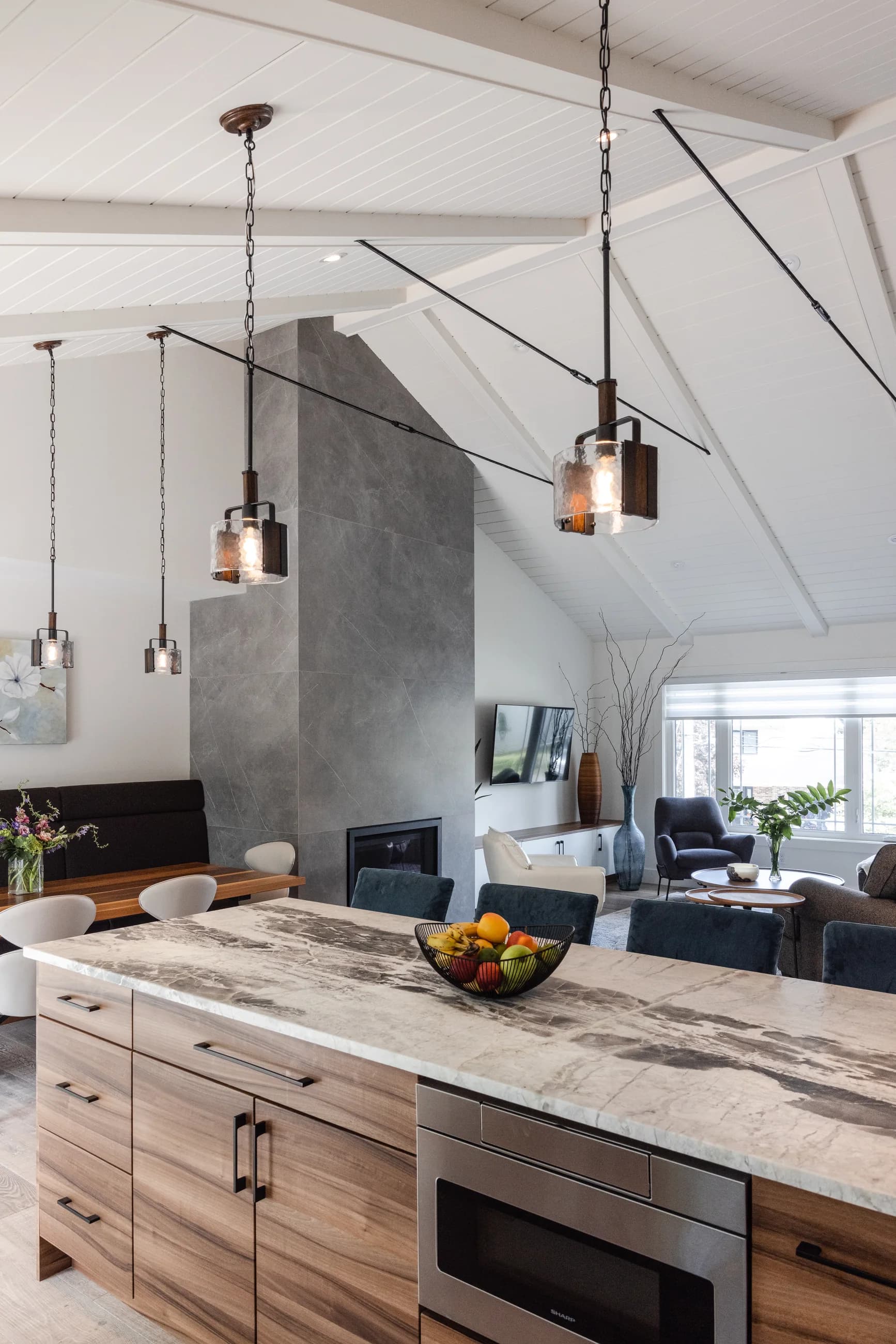 Bedford kitchen with a timber island, concrete hearth, and copper pendants