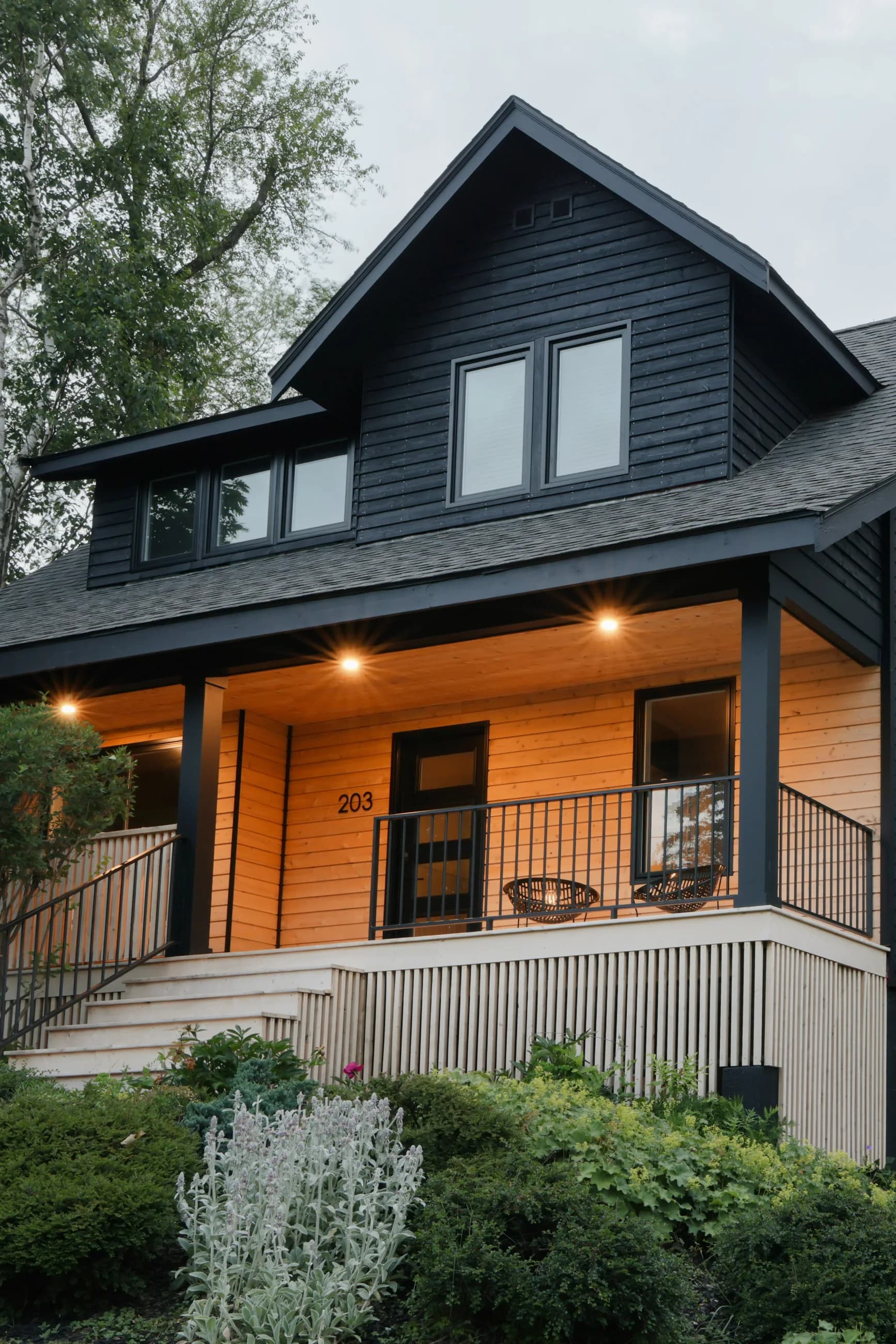 Dark-clad Crichton Street home with a warmly lit timber porch
