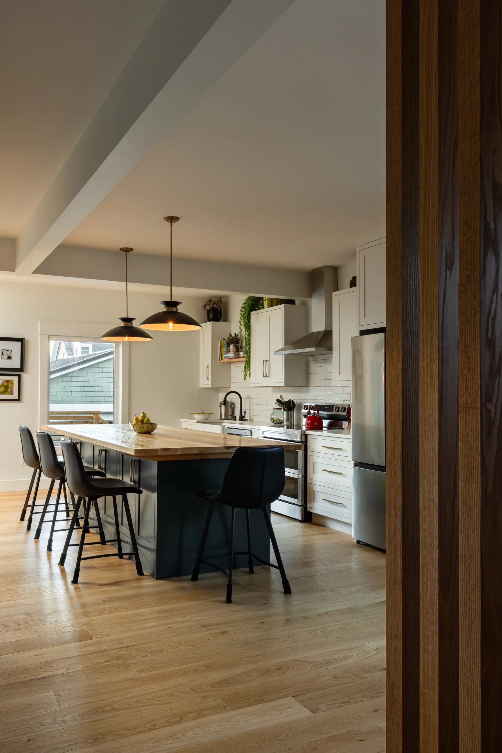 Rosebank House kitchen seen through a timber-screened doorway